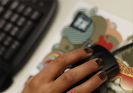 Students hand using a computer mouse