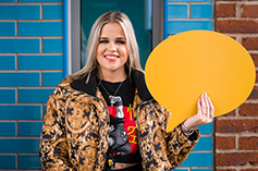 Student holding a speech bubble