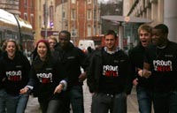 NTU students walking at tram stop in Proud to be NTU campaign tops