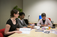 Students and lecturers discussing at a table