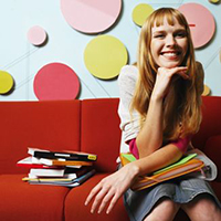 student sitting on sofa with books